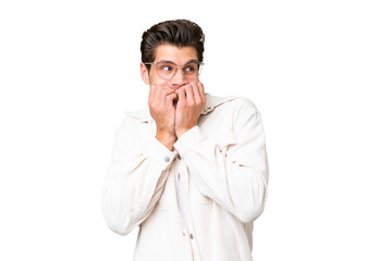 Young handsome caucasian man over isolated background nervous and scared putting hands to mouth