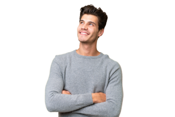 Young handsome caucasian man over isolated background looking up while smiling