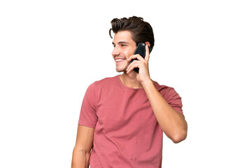 Young handsome caucasian man over isolated background keeping a conversation with the mobile phone...