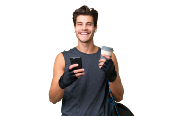 Young sport caucasian man with sport bag over over isolated background holding coffee to take away and a mobile