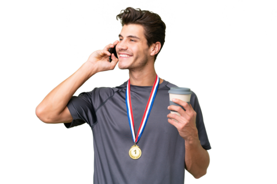 Young caucasian man with medals over isolated background holding coffee to take away and a mobile - Powered by Adobe
