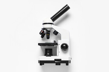 Modern microscope on white background, top view