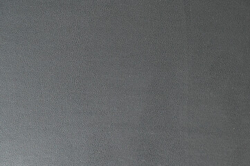 Macro shot of granular grey textured surface as abstract industrial background
