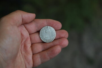 Medieval European silver coin in hand