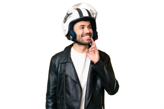 Young caucasian man with a motorcycle helmet over isolated chroma key background thinking an idea while looking up - Powered by Adobe