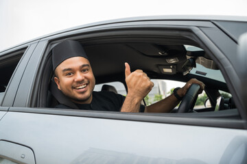 Asian muslim business man getting new car. Happy and excited. Smiling man islamic driving vehicle...