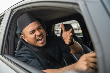 Driving during rush hour But the traffic is very congested. Angry muslim man. Young islamic man...