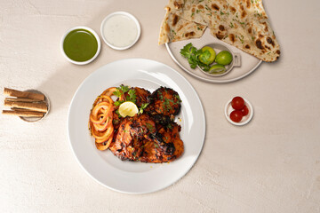 Grilled/ charcoal/ fried chicken with mayo dip and salad served in dish isolated on table top
