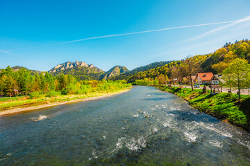 Peak Tri Koruny or Trzy Korony during day with green meadow and trees in spring. Pieniny National...