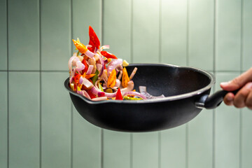 Culinary Skills cooking. Chef Expertly Stir-fries Vibrant Vegetables. Man mixing ingredient many...