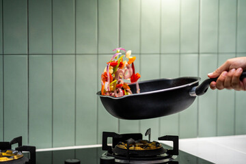 Culinary Skills cooking. Chef Expertly Stir-fries Vibrant Vegetables. Man mixing ingredient many...