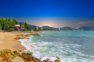 View of Patong Beach in the island of Phuket Thailand, turquoise blue waters of the Andaman and lush green mountains