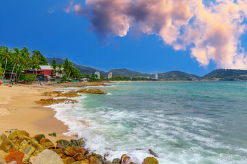 View of Patong Beach in the island of Phuket Thailand, turquoise blue waters of the Andaman and lush green mountains