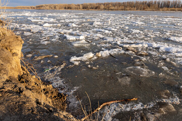 spring landscape, broken ice goes along the river. ice drift along the river
