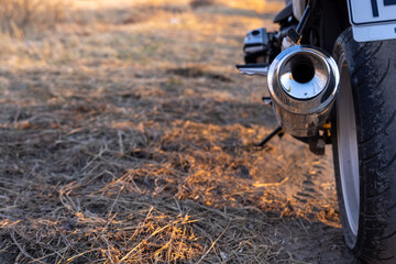 shiny details of a white motorcycle in the rays of the setting sun
