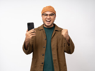 Young asian man using smartphone standing on isolated white background. He texting on cell phone. Dressing with jacket and jean.