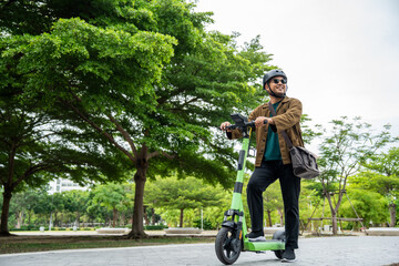 Young Asian man ride scooter EV eco friendly transport. Sustainable save energy lifestyle. Commute and carbon neutral transportation. Asian tourist man put on helmet ride the scooter EV