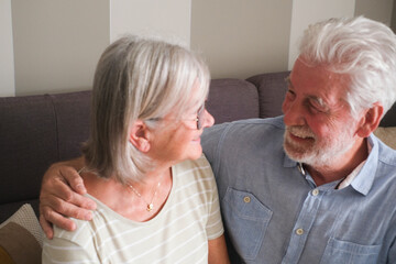 Senior couple in their 70s sharing loving and tender moments at home. A heartwarming scene of...