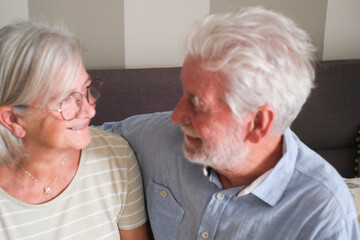 Senior couple in their 70s sharing loving and tender moments at home. A heartwarming scene of...