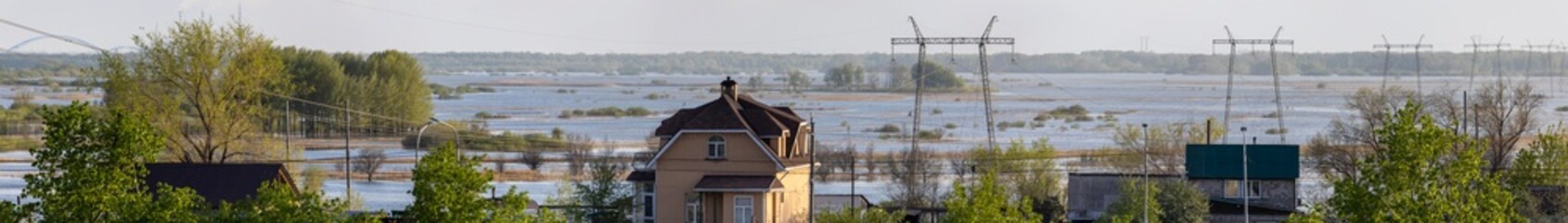 view of houses and a field flooded with water from the height of a multi-story building
