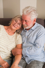 Senior couple in their 70s sharing loving and tender moments at home. A heartwarming scene of...