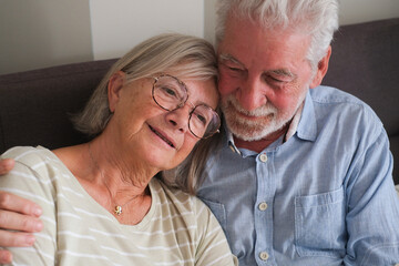 Senior couple in their 70s sharing loving and tender moments at home. A heartwarming scene of...
