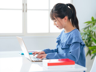 Girl using laptop in room