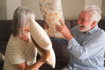 Senior couple in their 70s sharing loving and tender moments at home. A heartwarming scene of...