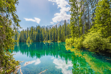 Karersee mountain lake in the Dolomites landscape, South Tyrol alps, Italy, also known lake...