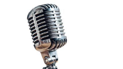 A silver vintage microphone stands out against a black backdrop, evoking a nostalgic feeling.