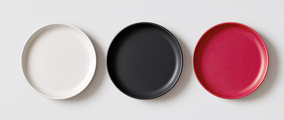 Three plates of different colors are shown on a white background