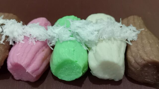 Colorful getuk with grated coconut topping.
 Gethuk is Indonesian Javanese snack made from cassava. 