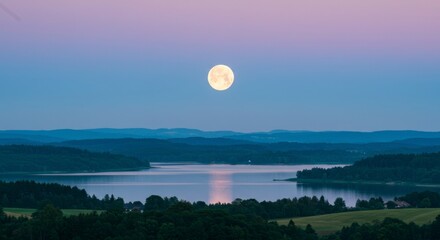 Full moon over a lake at dusk
