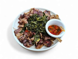 Grilled beef and greens with spicy chili sauce served on ceramic plate, ideal for culinary content,...