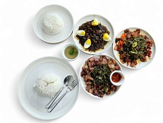 Overhead shot of a full lunch set with rice, meat, vegetables, sambal, and small side dishes on...