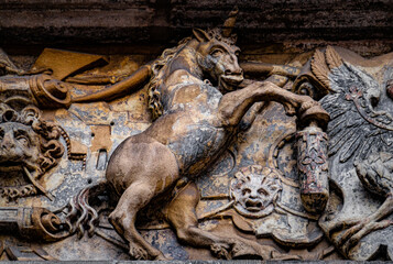 Medieval stone panel with unicorns and royal coat of arms