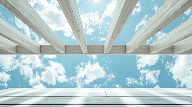 White wooden pergola against a vibrant blue sky filled with fluffy clouds. Great for outdoor spaces, architecture or sunny day summer concepts.