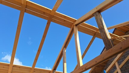 Wooden construction frame against clear blue sky