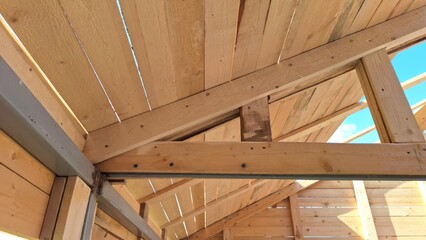 Wooden roof truss architecture and construction with beams and planks