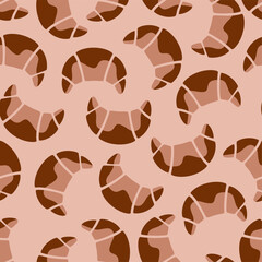 Seamless croissant pattern in brown and beige on light background.