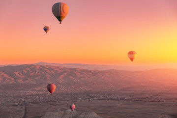 Aerial view of hot air balloons over Cappadocia at sunrise