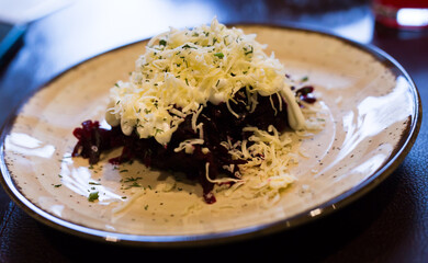 dish of beets, cheese, mayonnaise on a plate in restaurant