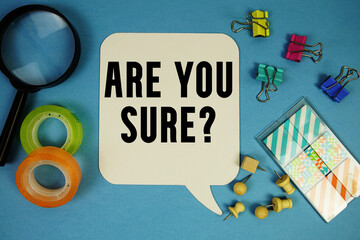 Are You Sure? text with magnifying glass on blue background