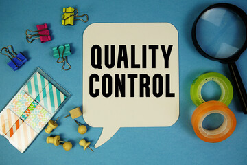 Quality Control text with magnifying glass on blue background