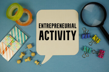 Entrepreneurial Activity text with magnifying glass on blue background