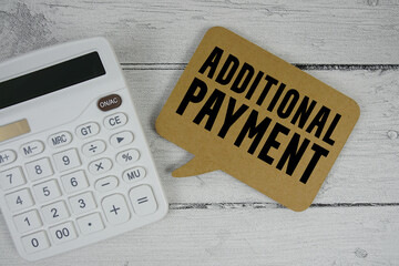 Additional Payment text with calculator on wooden background