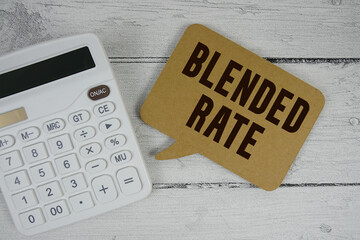 Blended Rate text with calculator on wooden background