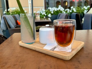 A cup of tea and lemonade are on a table in a summer cafe. High quality photo