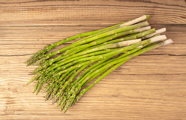 Bunch of Raw Garden Asparagus on Wood Rustic Tabletop. Fresh Green Spring Vegetables