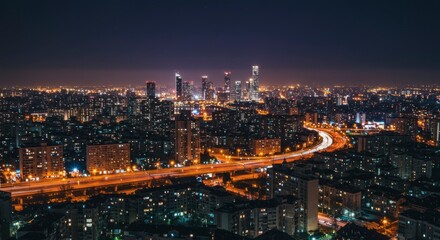 Obraz premium Night cityscape panorama; illuminated buildings, highways, and city lights